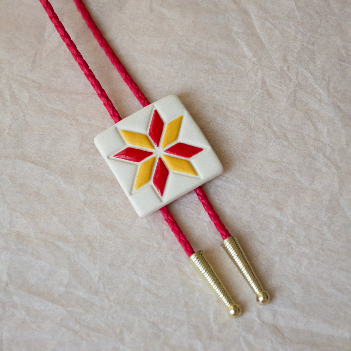 Yellow and Red Eight Pointed Star Quilt Square Bolo Tie
