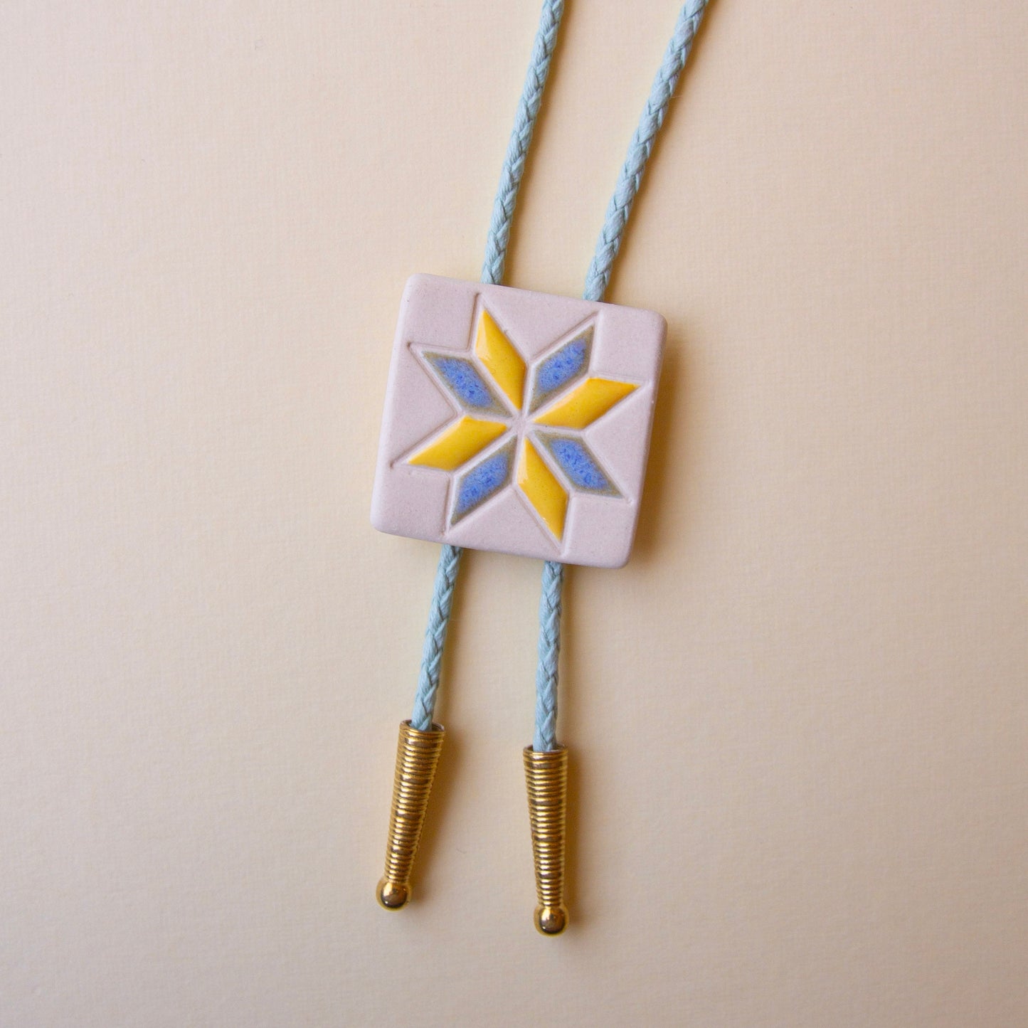 Yellow and Blue Eight Pointed Star Quilt Square Bolo Tie
